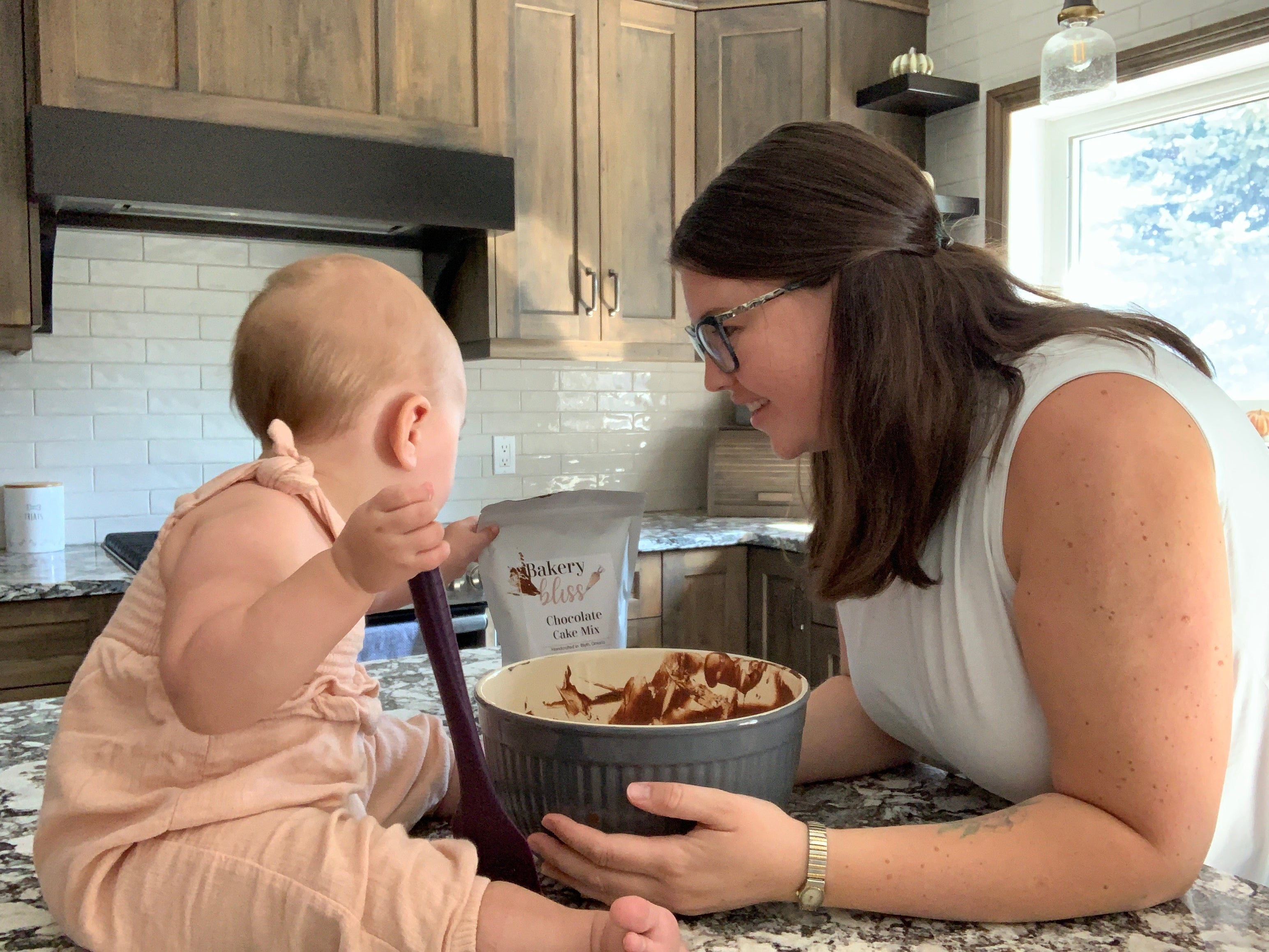 Jessica and her daughter in the kitchen making Bakery Bliss Chocolate Cake